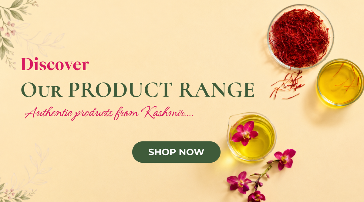 A promotional banner on a pale yellow background featuring the text 'Discover Our Product Range: Authentic products from Kashmir' above a dark green 'Shop Now' button. On the right, there is a glass bowl filled with red saffron threads alongside small glass beakers containing golden oil and a bright pink orchid flower.